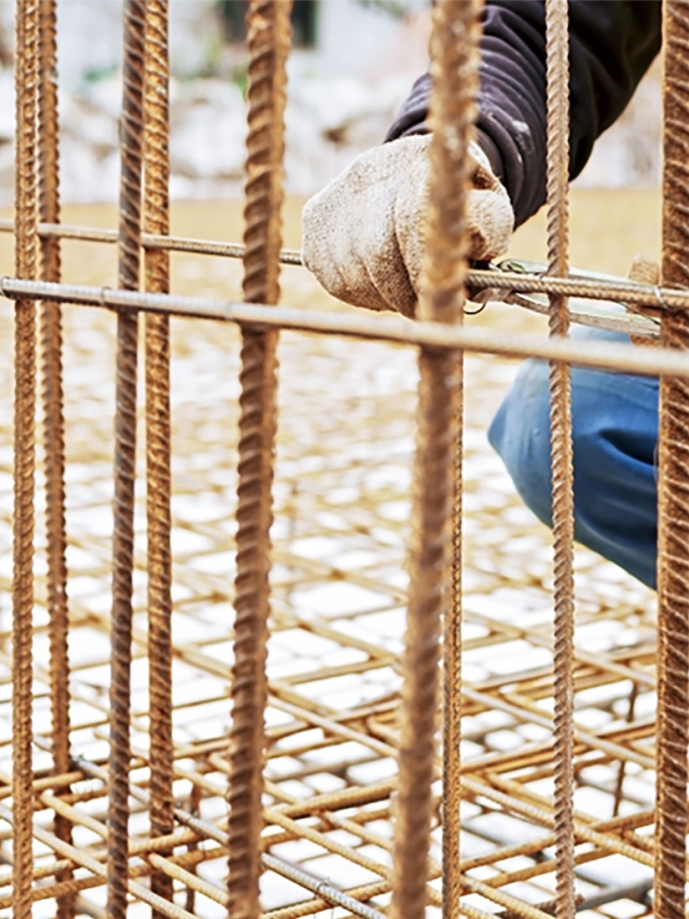 Construction worker installing a foundation for an industrial building.